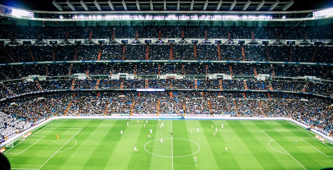 A packed football stadium under floodlights, streamed live in 4K on VizWriting IPTV